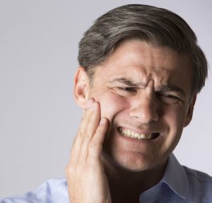 Studio Portrait Of Man Suffering With Toothache